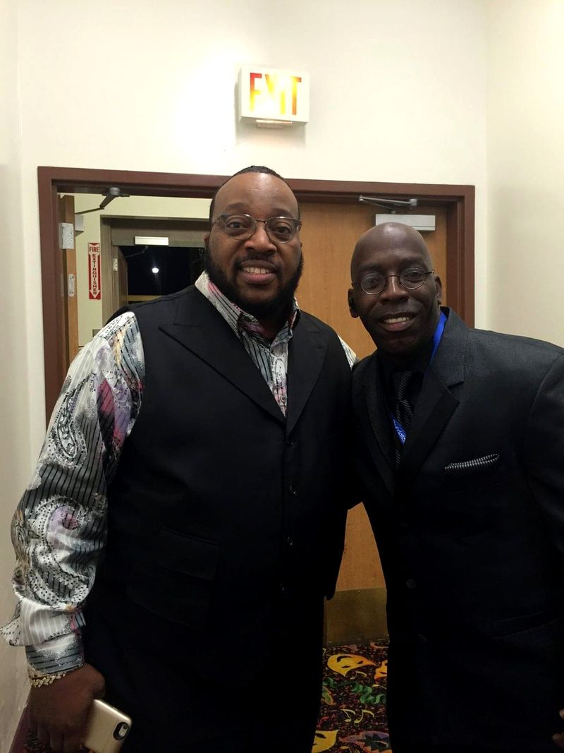 Doc Lewis with a friend in a vest at an event