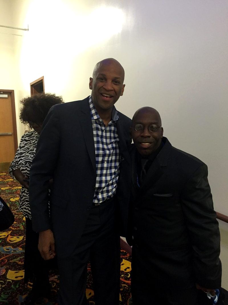 Doc Lewis with a friend in a checked shirt at an event