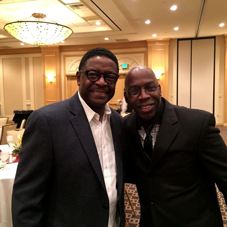 Doc Lewis with a friend in a suit at a banquet