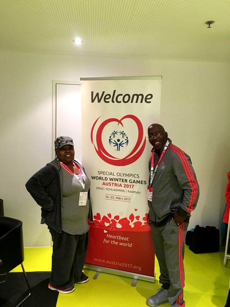 Doc Lewis beside the welcome banner of the Special Olympics World Winter Games, Austria 2017